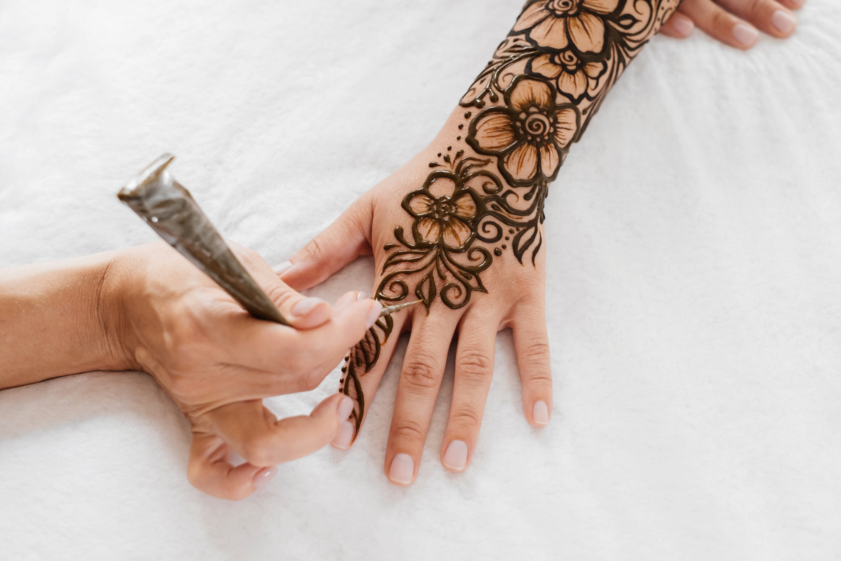 Tattoo Artist Drawing Henna on Arm
